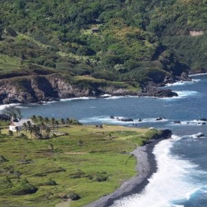 A breathtaking beach with a serene island in the distance on Maui tour.