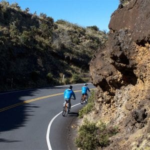 Guests riding downhill on a Maui sunrise bike tour.