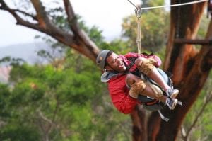 Man Having Fun Zipline in Maui