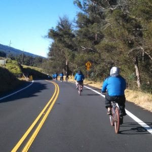 A scenic mid-day bike tour in Maui, with people biking down Haleakala.