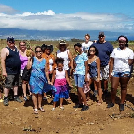 Tourists on a sightseeing tour at Maui pineapple farm.