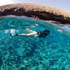 Snorkel beside Sea Wall on a Crystal-Clear Ocean