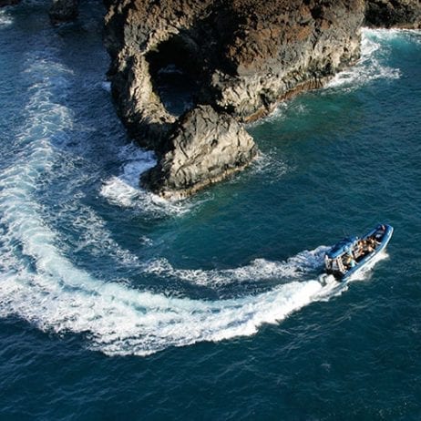 blue water rafting speeding around coastline