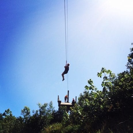 Brave visitor speeding down the zipline on Maui