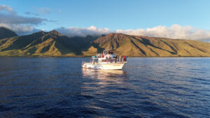 Maui Diamond dive boat at sunset with Maui in the background